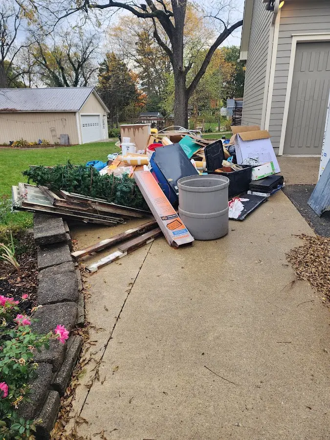 Dumpster being loaded with debris for Roofing Dumpster Rental in Minooka